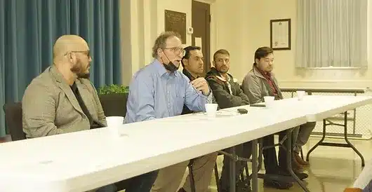 afghan refugees talk with members of the community