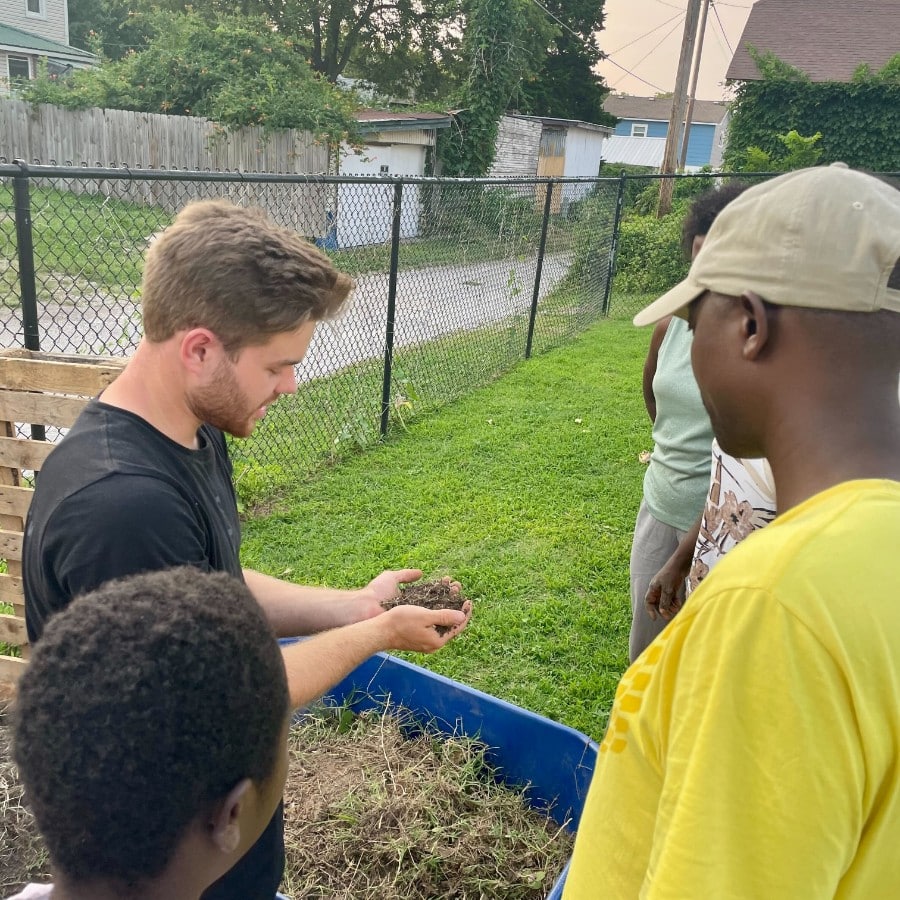 group learning about soil at the community garden