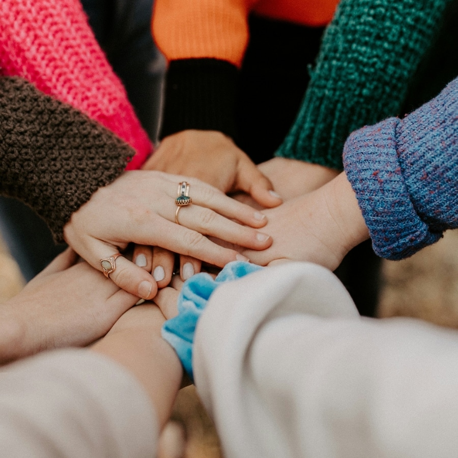 group of hands overlapping